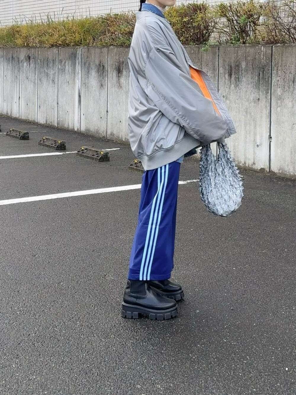 グレー系のMA-1、ブルー系のシャツ/ブラウス、シルバー系のバッグを着用したレディースの冬コーディネートの3枚目の写真