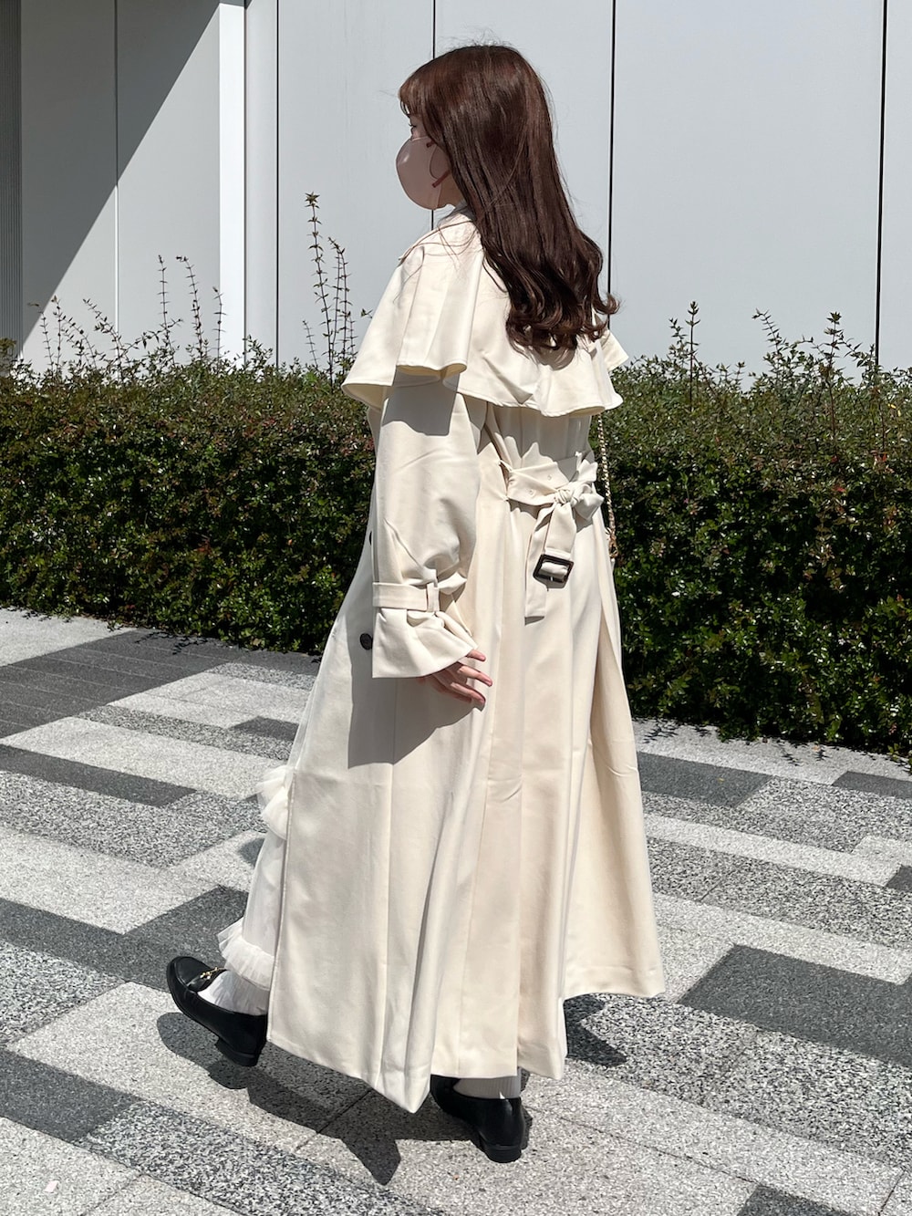 ホワイト系のカーディガン/ボレロ、ホワイト系のトレンチコート、ホワイト系のスカートを着用したレディースの春コーディネートの2枚目の写真