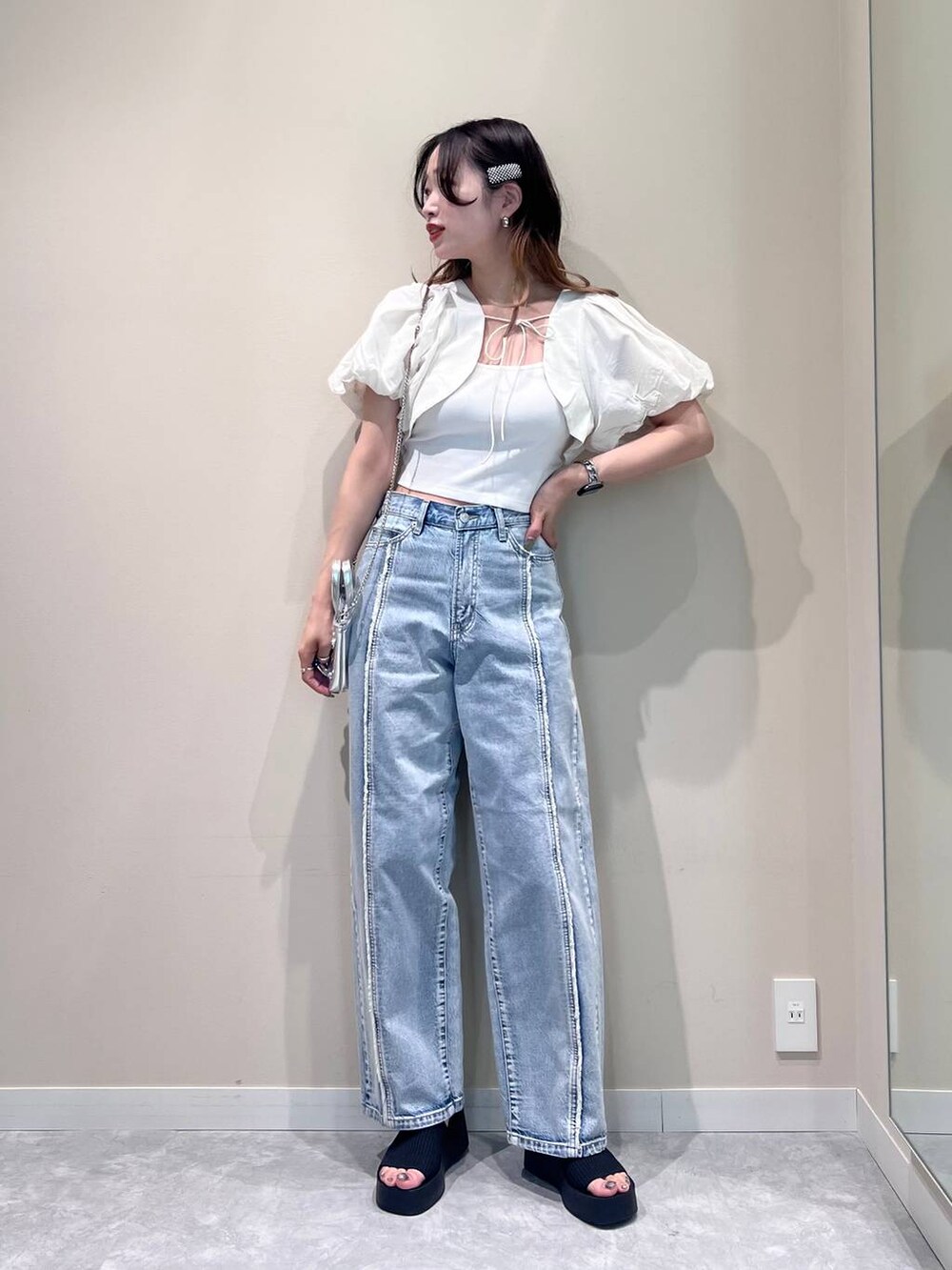 シルバー系のショルダーバッグ、ブラック系のサンダル、ホワイト系のTシャツ/カットソーを着用したレディースの夏コーディネートの4枚目の写真