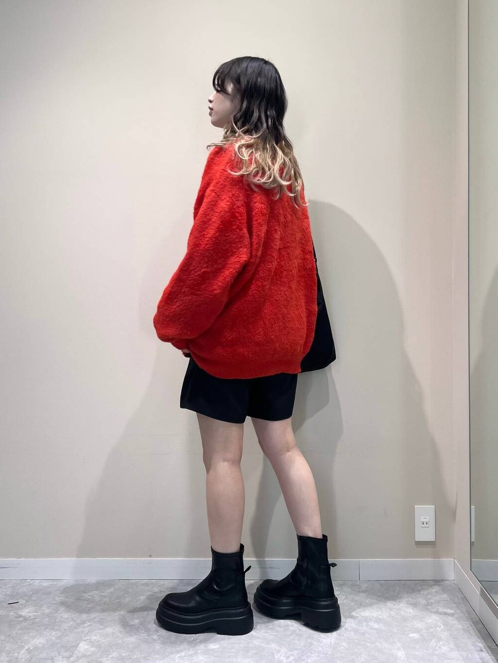 ブラック系のその他パンツ、ブラック系のブーツ、ホワイト系のTシャツ/カットソーを着用したレディースの冬コーディネートの3枚目の写真