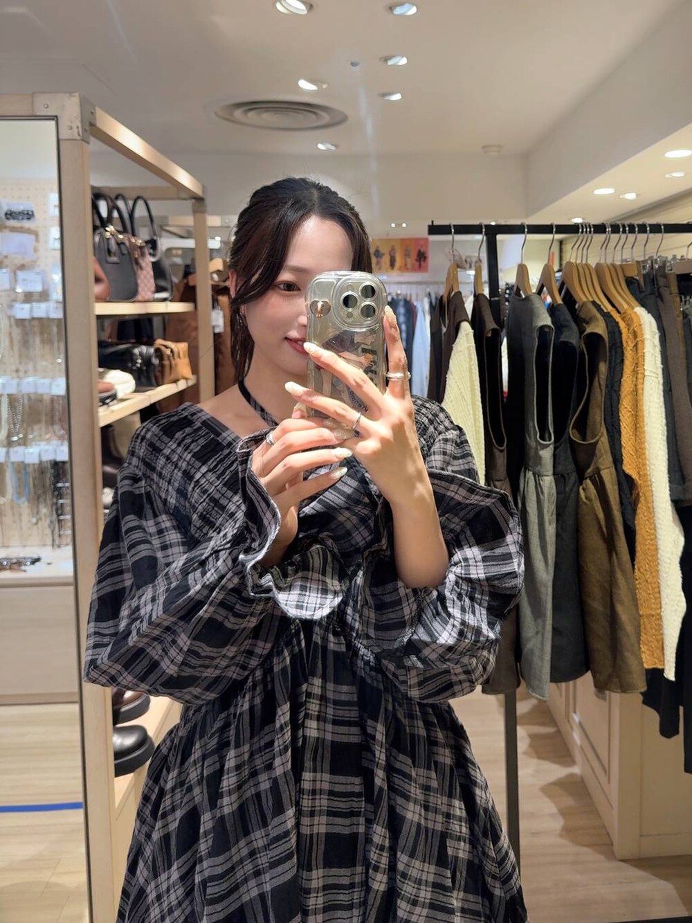 ブラック系のシャツ/ブラウス、ホワイト系のスマホケース/カバーを着用したレディースの秋コーディネートの2枚目の写真