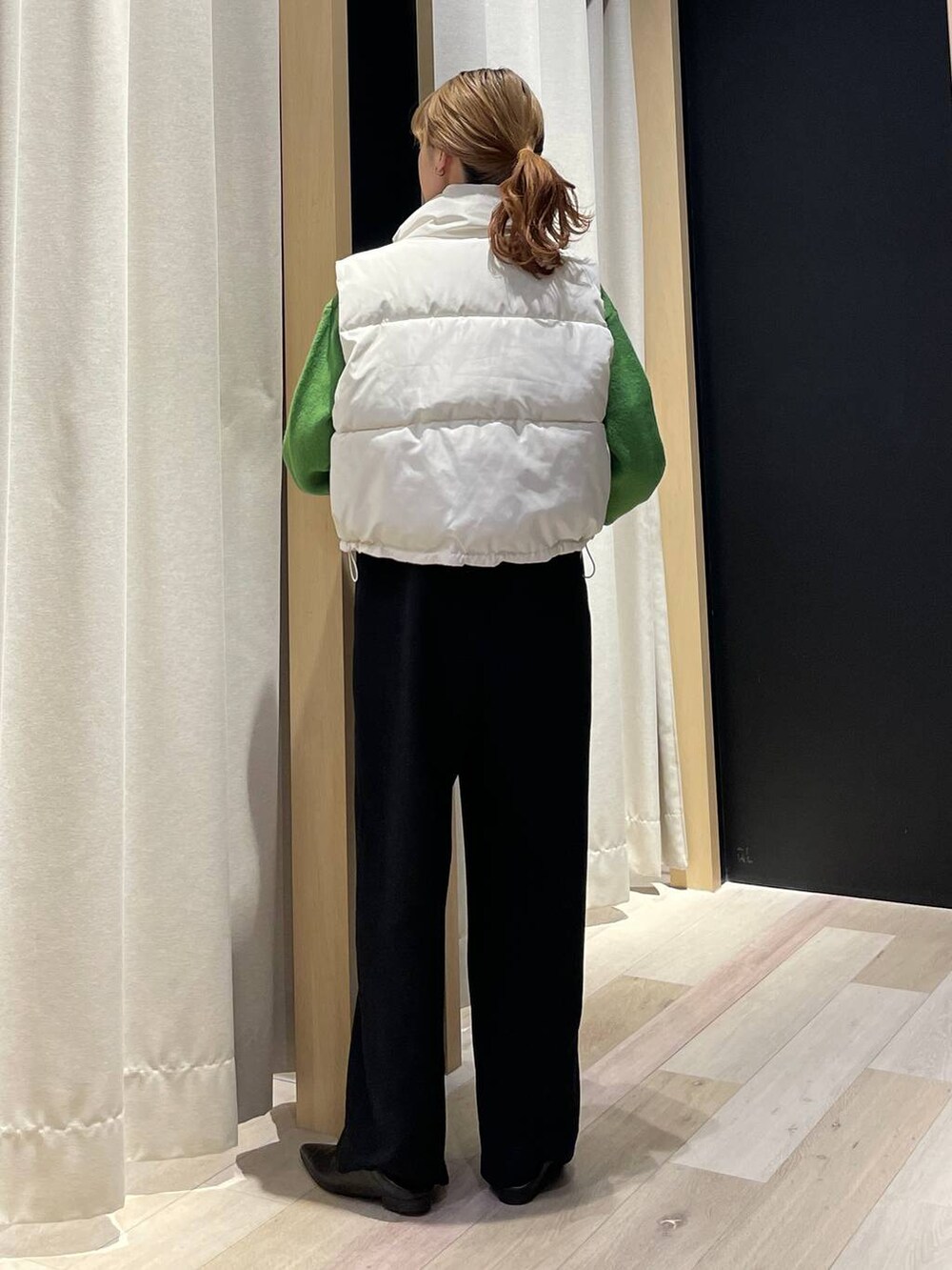 ブラック系のパンプス、グリーン系のニット/セーター、ブラック系のその他パンツを着用したレディースの冬コーディネートの3枚目の写真