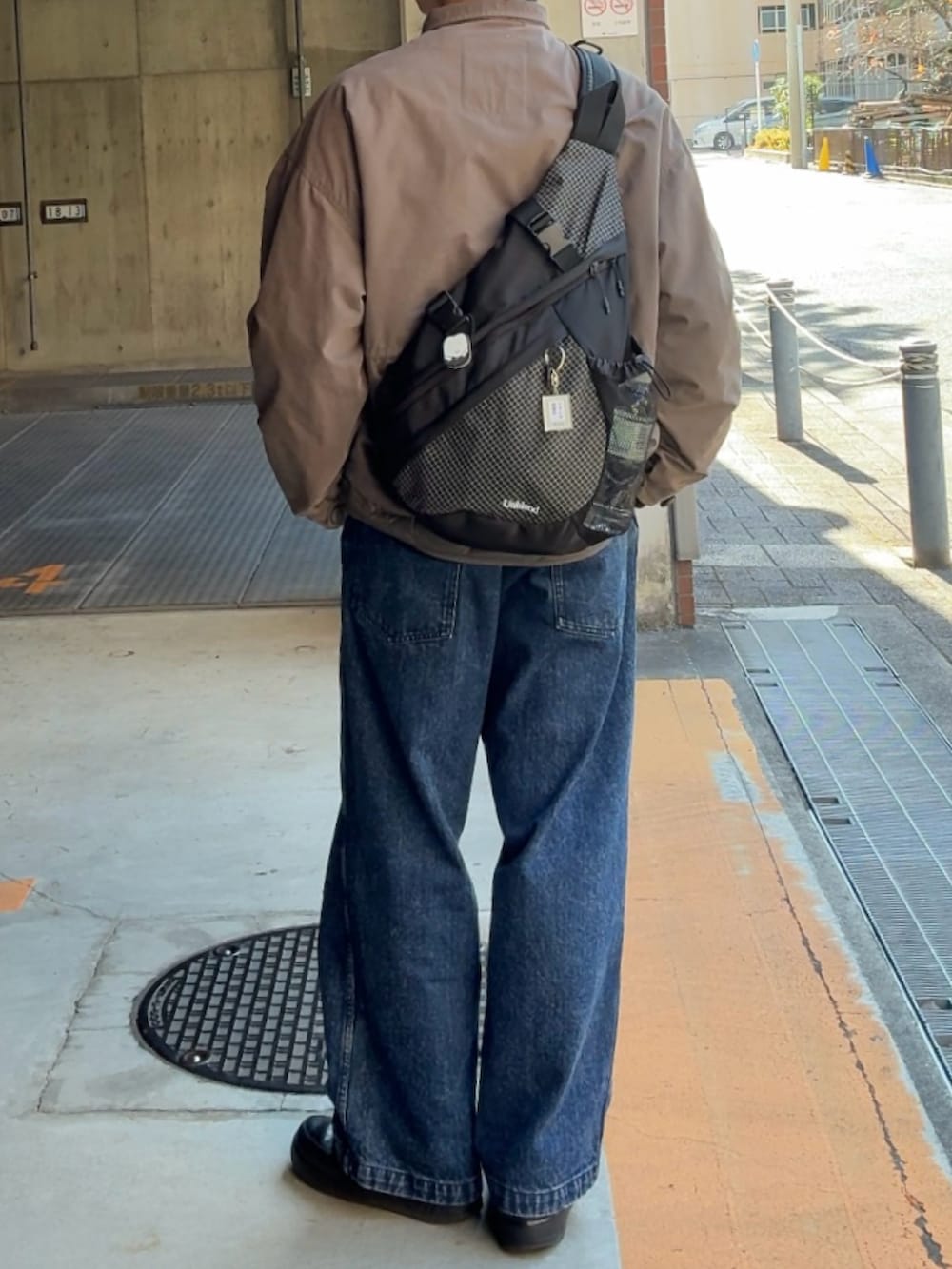 グリーン系のモッズコート、ブラック系のボディバッグ/ウエストポーチ、ブラック系のスウェットを着用したメンズの冬コーディネートの2枚目の写真