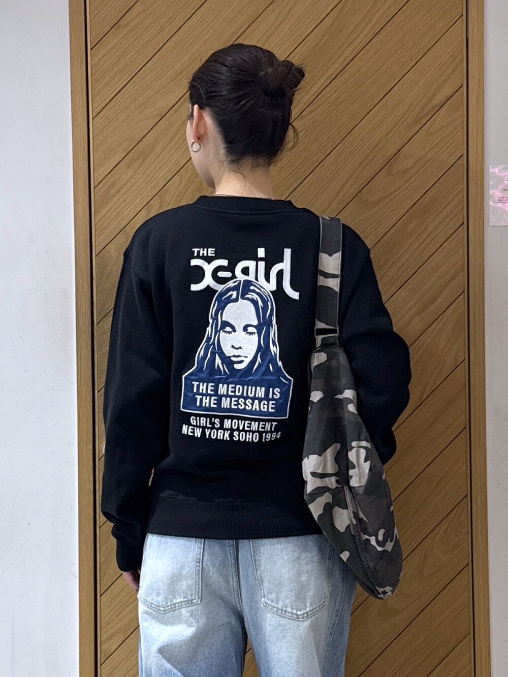 ブラック系のスウェット、その他のショルダーバッグ、ブラック系のデニムパンツを着用したレディースの秋コーディネートの4枚目の写真