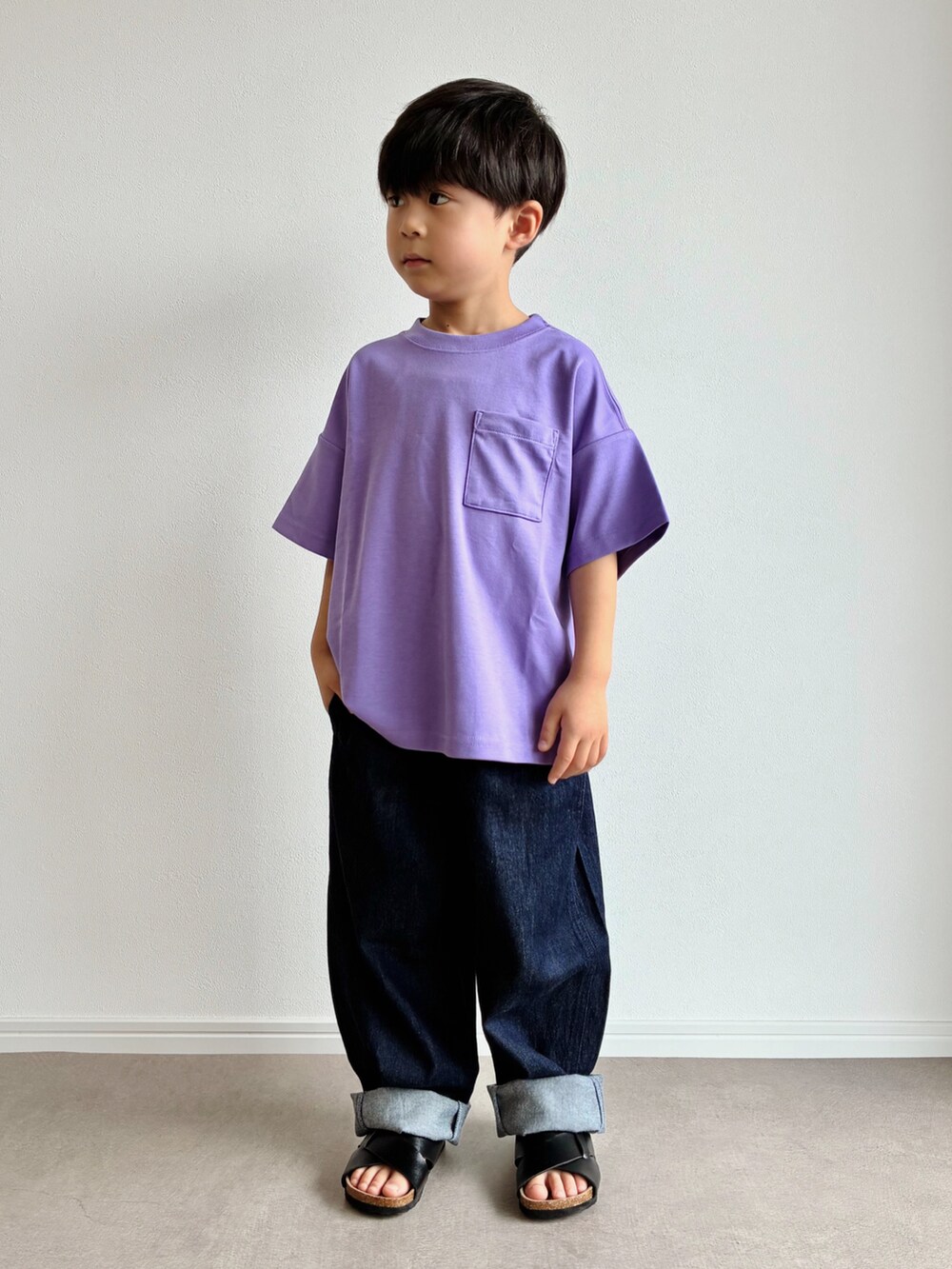 パープル系のTシャツ/カットソー、ブラック系のサンダル、ブルー系のデニムパンツを着用したキッズの夏コーディネートの2枚目の写真