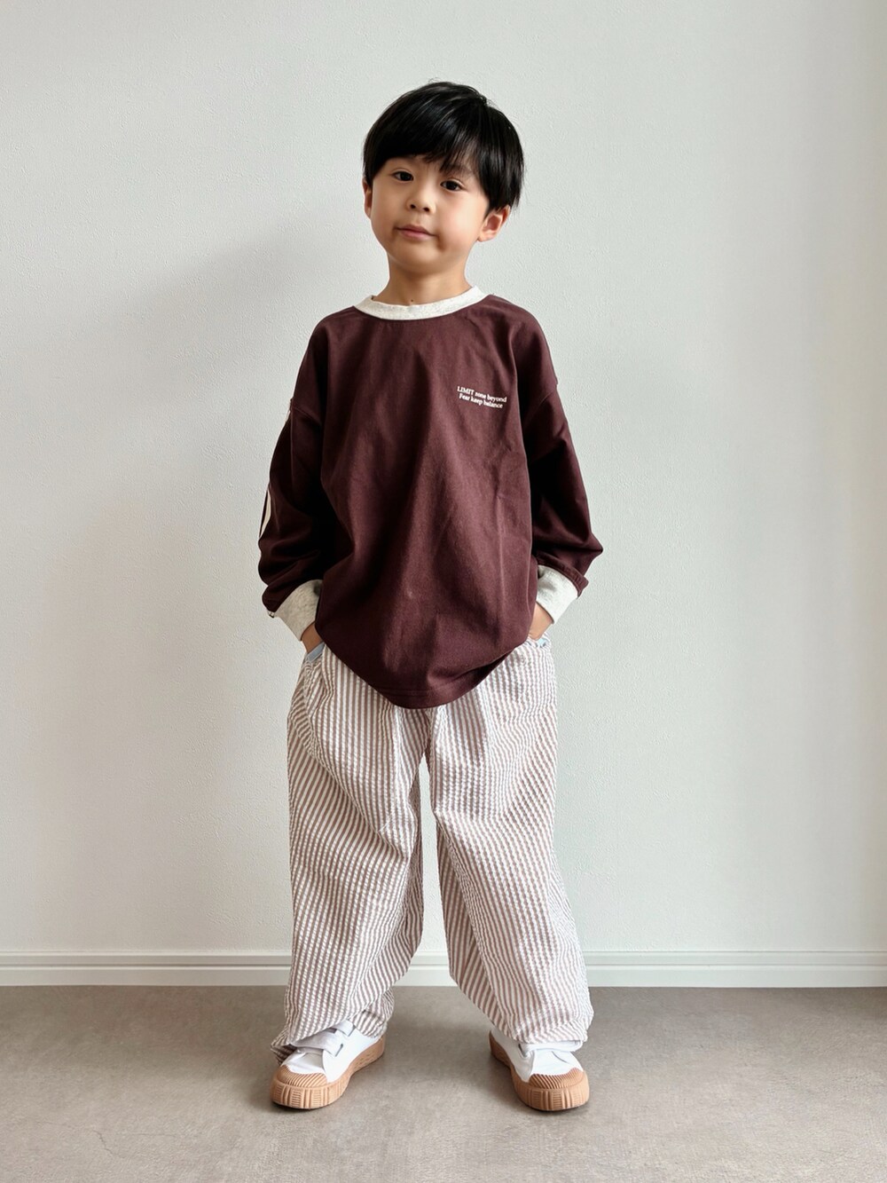 ブラウン系のTシャツ/カットソー、ブラウン系のその他パンツ、ベージュ系のスリッポンを着用したキッズの秋コーディネートの2枚目の写真