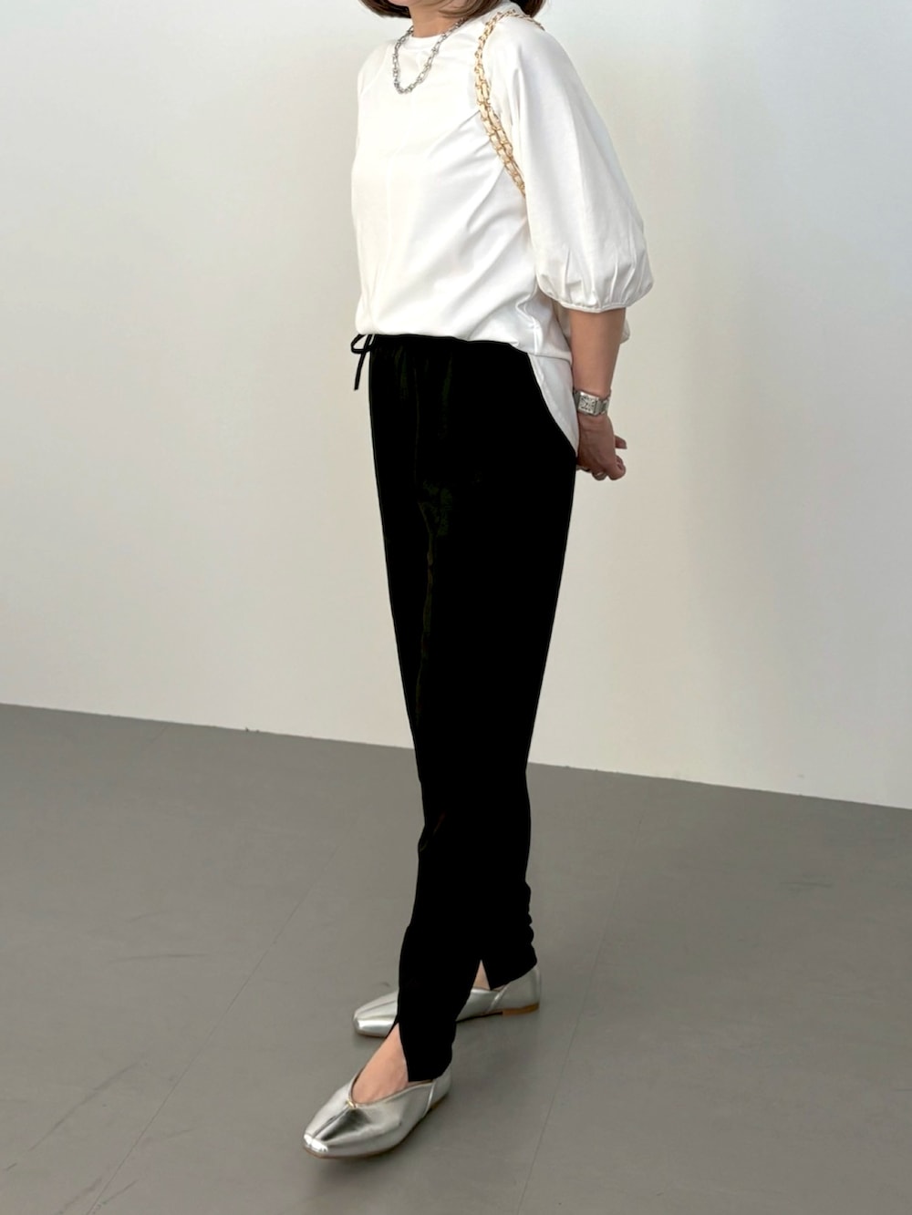 ホワイト系のTシャツ/カットソー、ブラック系のその他パンツ、シルバー系のパンプスを着用したレディースの春コーディネートの3枚目の写真