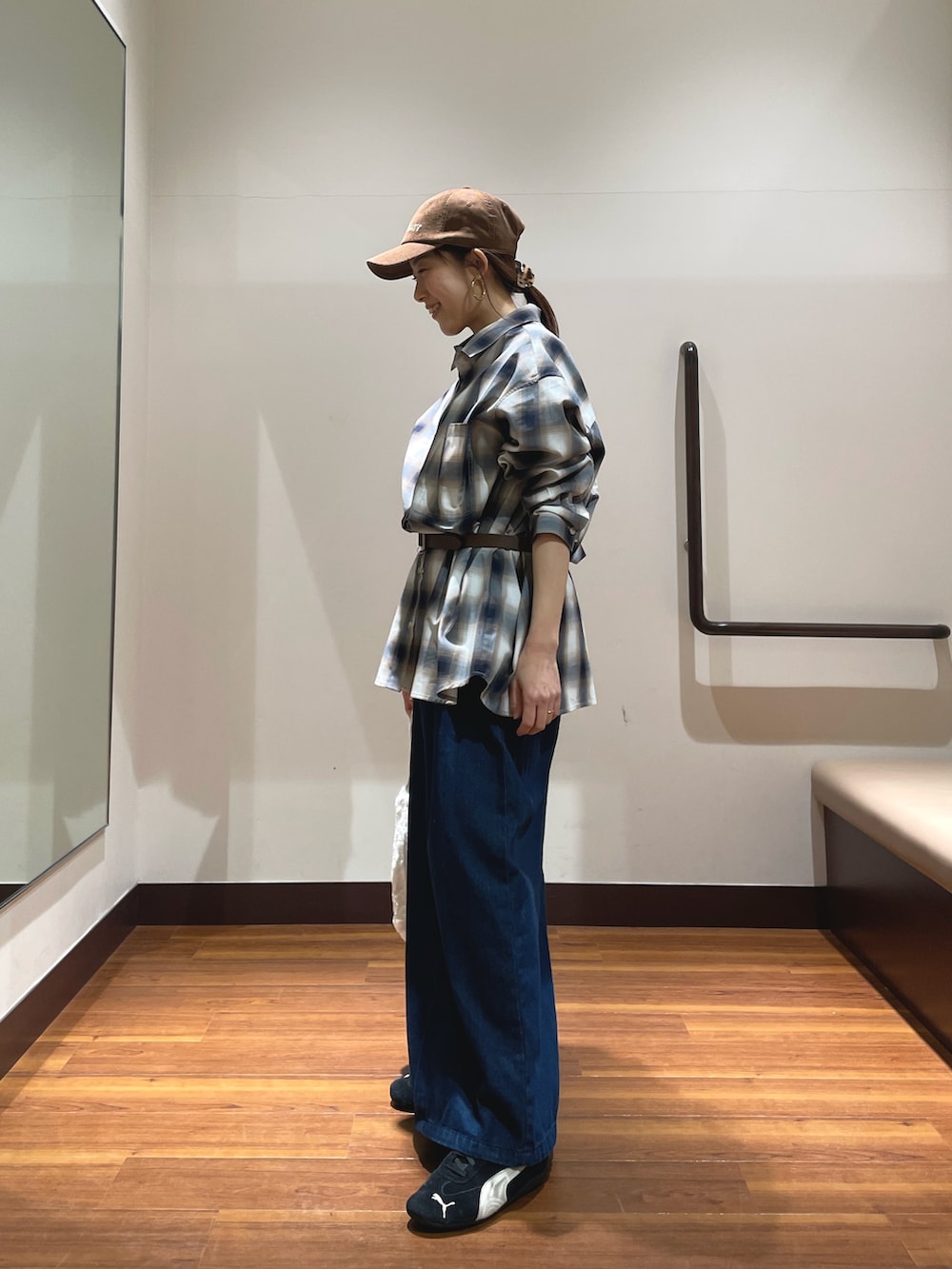 ブルー系のワンピース、ブラック系のスニーカー、ホワイト系のショルダーバッグを着用したレディースの春コーディネートの2枚目の写真