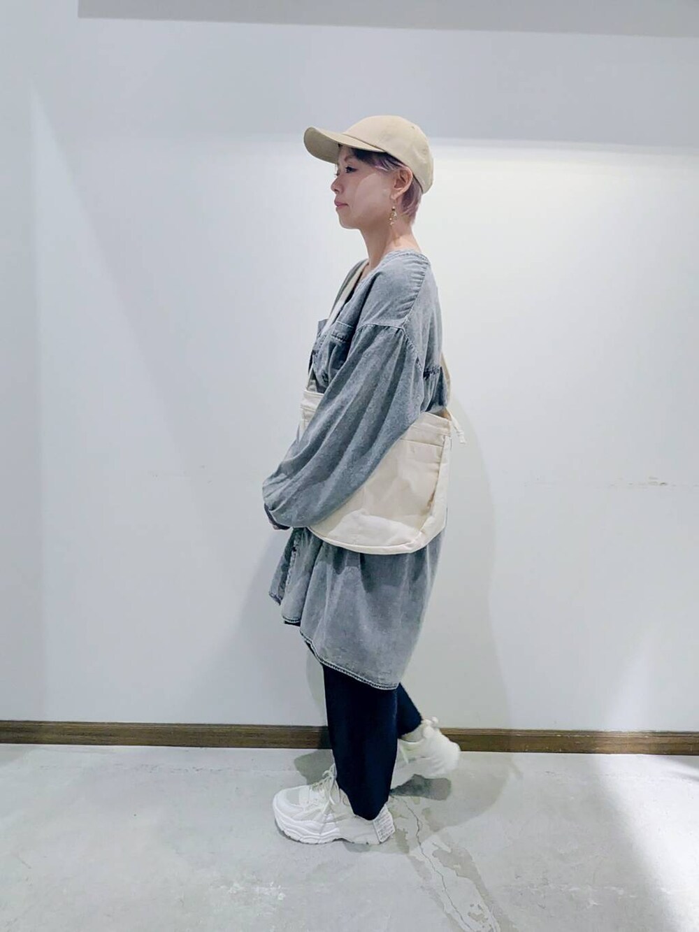 ブラック系のタンクトップ、ホワイト系のショルダーバッグ、グレー系のその他パンツを着用したレディースの秋コーディネートの4枚目の写真