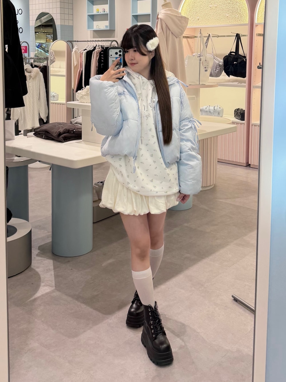 ブルー系のダウンジャケット/コート、ホワイト系のパーカー、ホワイト系のスカートを着用したレディースの冬コーディネートの2枚目の写真