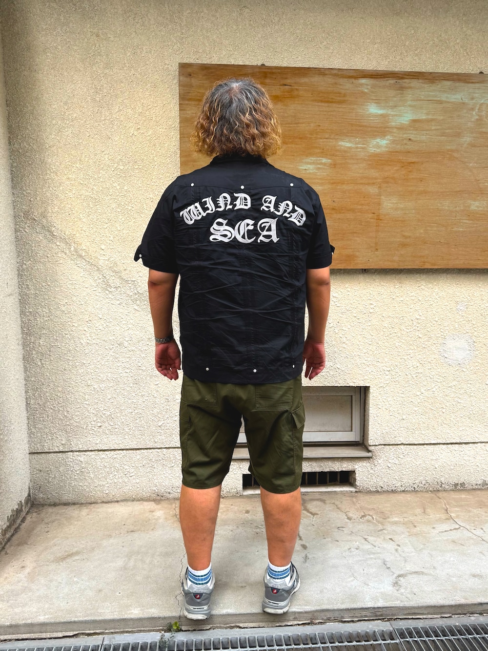 グリーン系のカーゴパンツ、ブラック系のシャツ/ブラウス、グレー系のスニーカーを着用したメンズの秋コーディネートの2枚目の写真