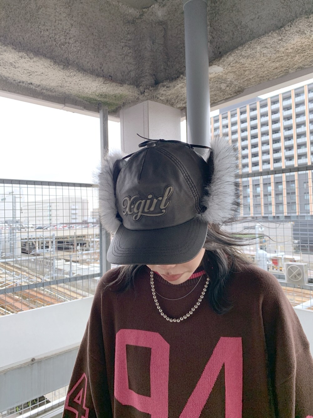 ブラウン系のニット/セーター、ブラック系のデニムパンツ、ブラック系のキャップを着用したレディースの秋コーディネートの3枚目の写真