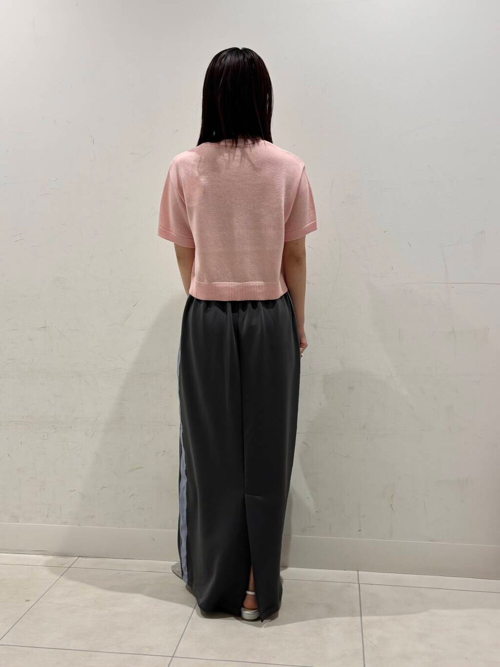 ブラック系のショルダーバッグ、シルバー系のパンプス、グレー系のスカートを着用したレディースの春コーディネートの3枚目の写真