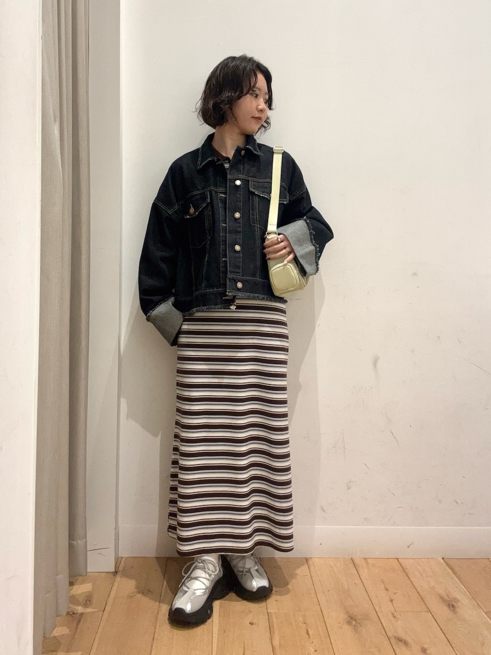 ブラウン系のワンピース、ブルー系のデニムジャケットを着用したレディースの冬コーディネートの3枚目の写真