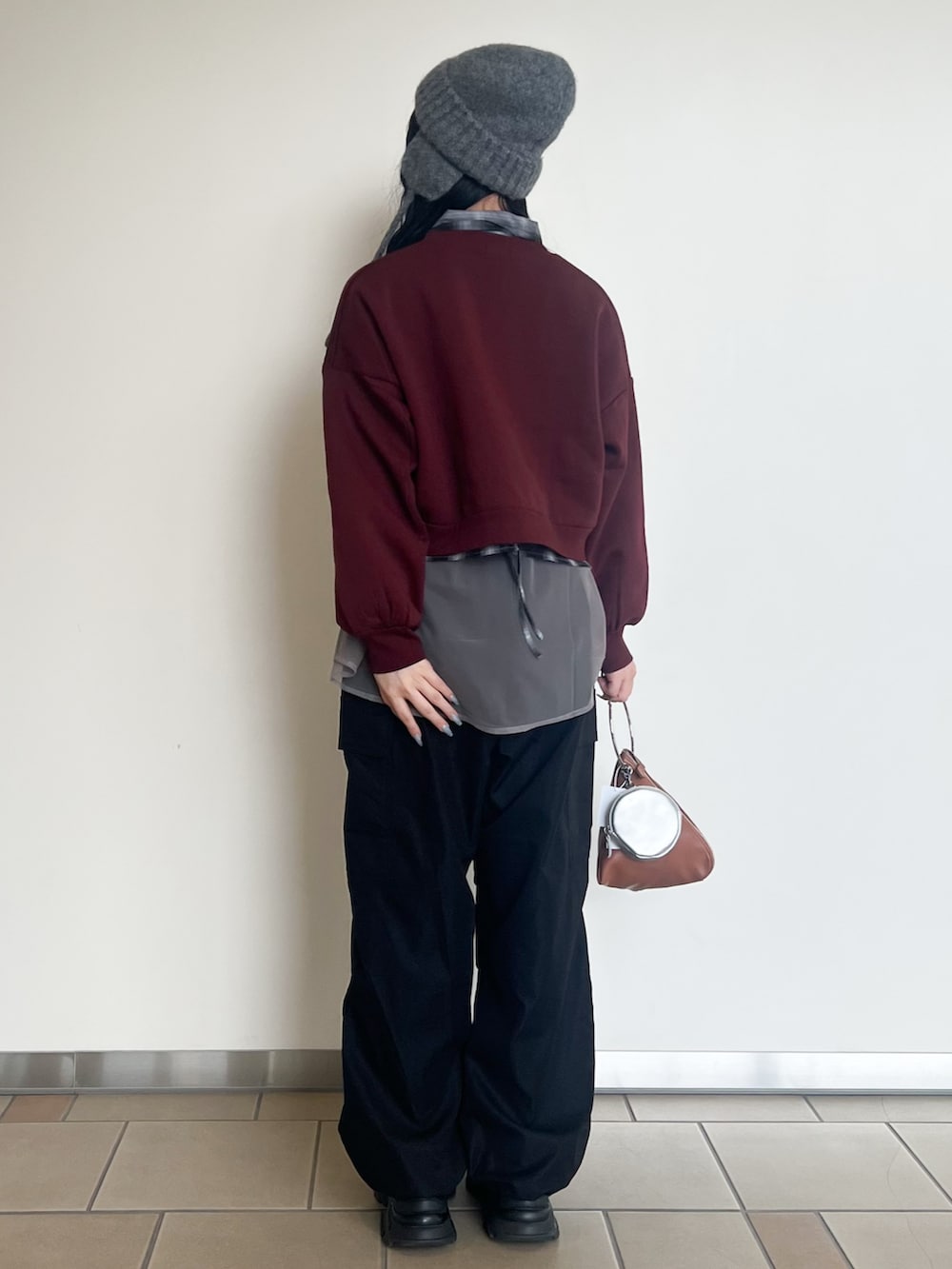 ブラック系のその他パンツ、グレー系のシャツ/ブラウス、レッド系のスウェットを着用したレディースの秋コーディネートの3枚目の写真
