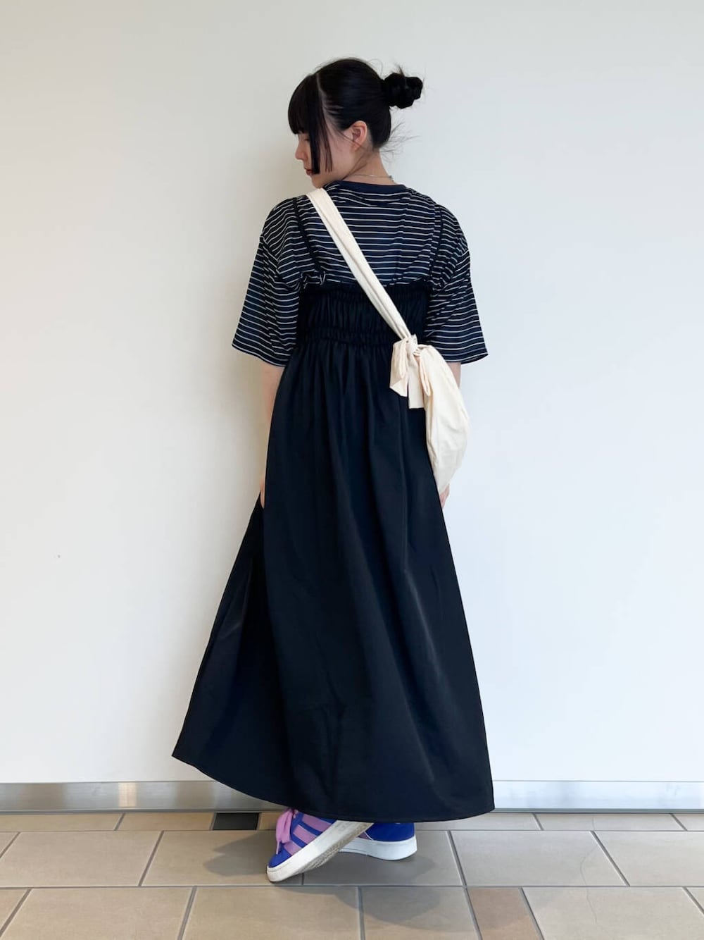 ホワイト系のショルダーバッグ、ブラック系のワンピース、ブルー系のTシャツ/カットソーを着用したレディースの夏コーディネートの3枚目の写真