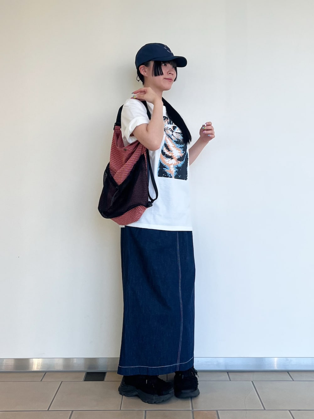 その他のTシャツ/カットソー、ブルー系のスカート、レッド系のバックパック/リュックを着用したレディースの夏コーディネートの2枚目の写真