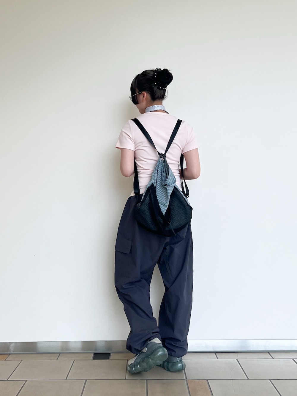 ピンク系のTシャツ/カットソー、グレー系のその他パンツ、ブルー系のバックパック/リュックを着用したレディースの夏コーディネートの2枚目の写真