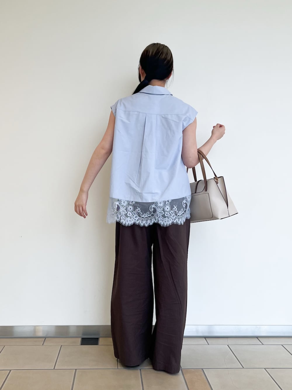 ブルー系のシャツ/ブラウス、ブラウン系のその他パンツ、ベージュ系のトートバッグを着用したレディースの夏コーディネートの2枚目の写真