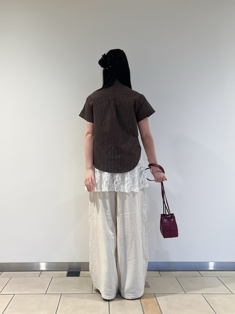 ベージュ系のその他パンツ、レッド系のショルダーバッグを着用したレディースの春コーディネートの3枚目の写真