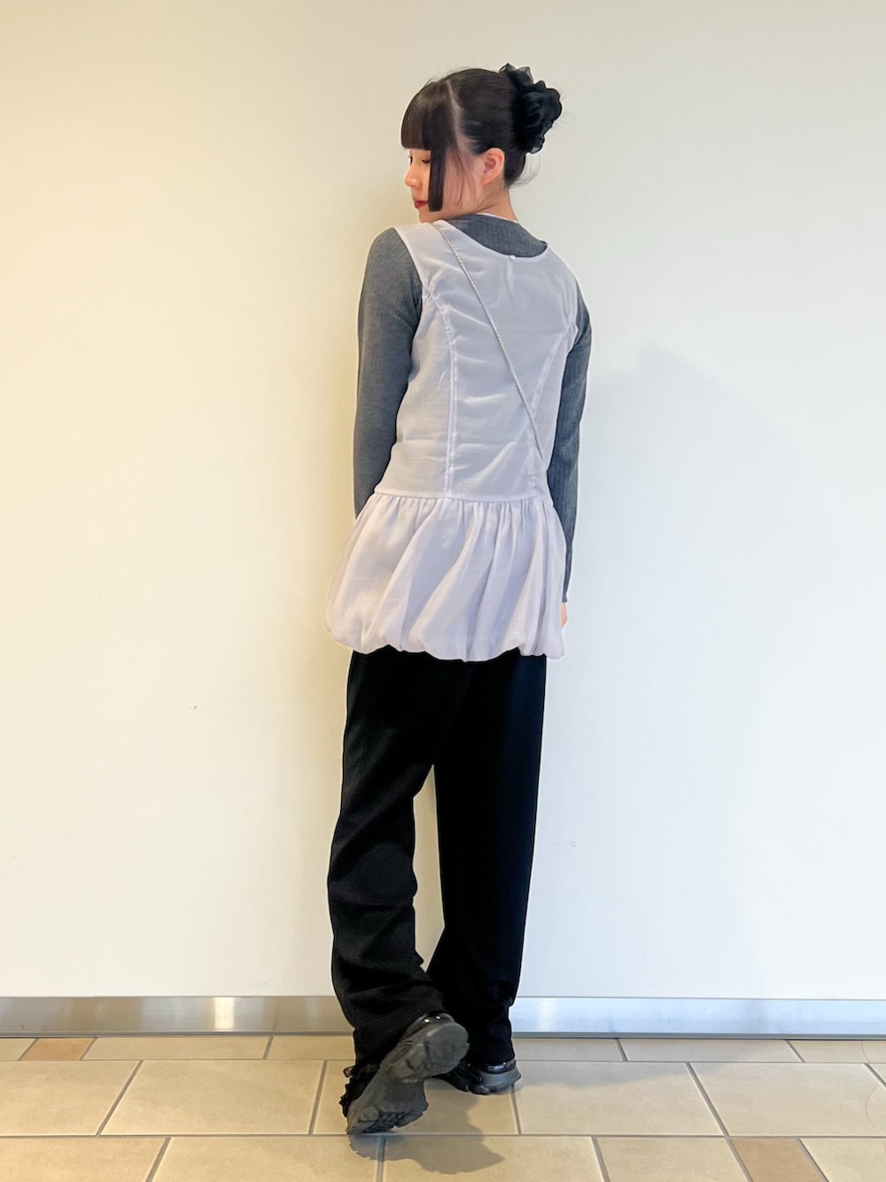 グレー系のニット/セーター、ブラック系のその他パンツ、ピンク系のショルダーバッグを着用したレディースの秋コーディネートの3枚目の写真