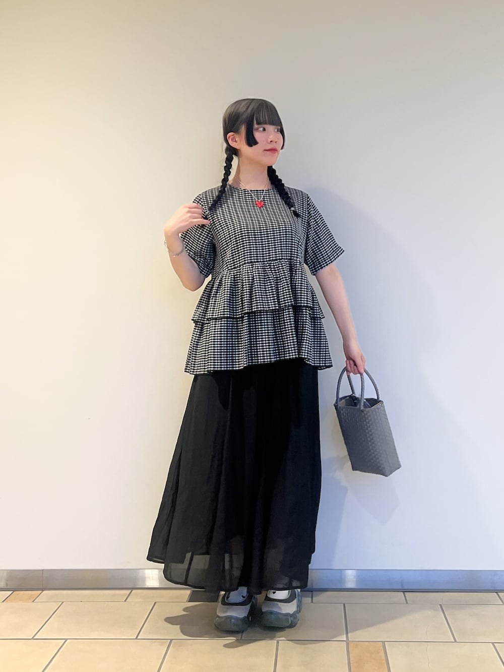 グレー系のトートバッグ、ブラック系のシャツ/ブラウス、ブラック系のスカートを着用したレディースの夏コーディネートの2枚目の写真