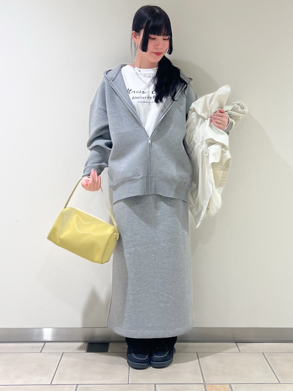 ホワイト系のTシャツ/カットソー、イエロー系のトートバッグ、ホワイト系のパーカーを着用したレディースの春コーディネートの3枚目の写真
