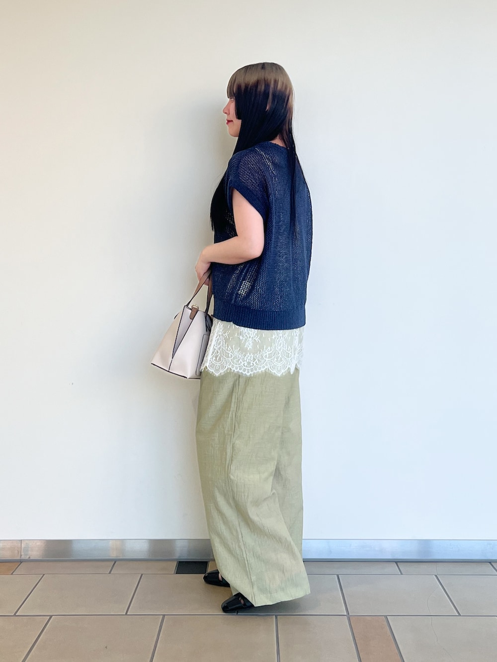 ベージュ系のキャミソール、ブルー系のベスト、グリーン系のその他パンツを着用したレディースの夏コーディネートの2枚目の写真