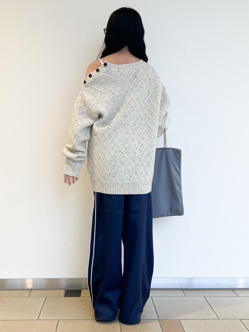 ホワイト系のニット/セーター、ブルー系のその他パンツ、グレー系のトートバッグを着用したレディースの冬コーディネートの2枚目の写真