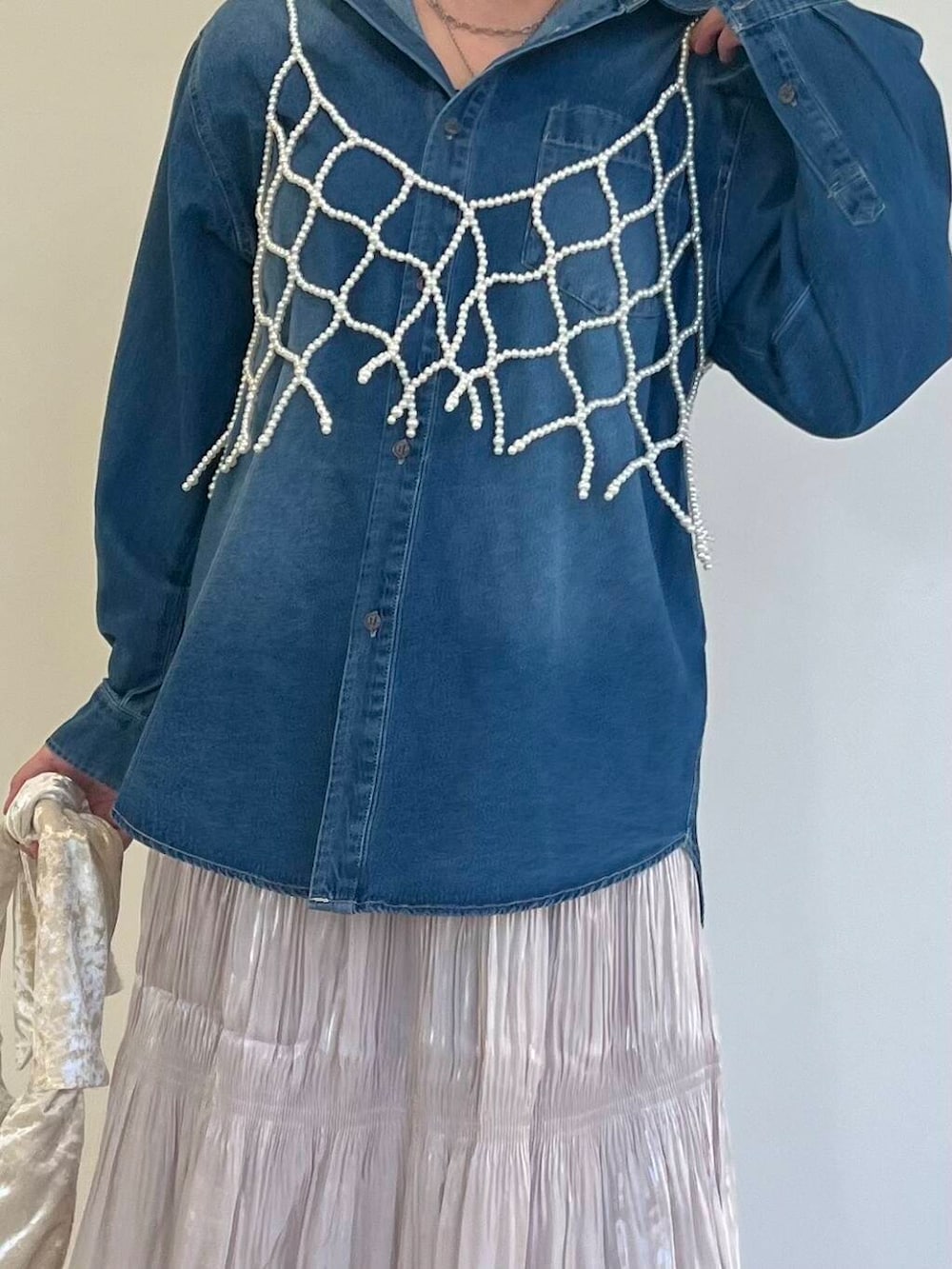 ベージュ系のハンドバッグ、ブルー系のシャツ/ブラウス、ホワイト系のスカートを着用したレディースの秋コーディネートの3枚目の写真