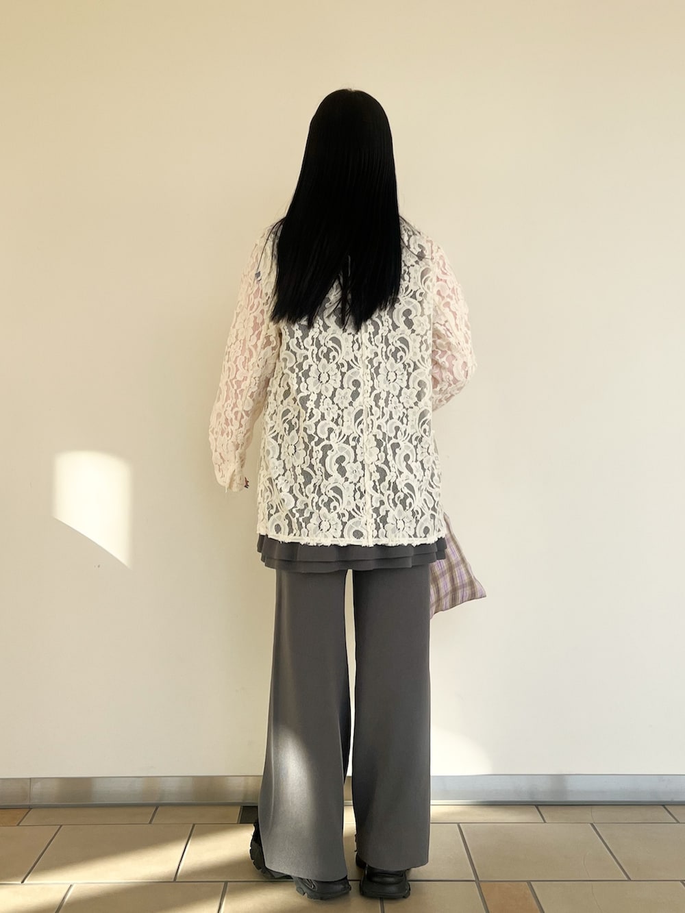 ピンク系のニット/セーター、グレー系のセットアップ、ホワイト系のその他アウターを着用したレディースの春コーディネートの2枚目の写真