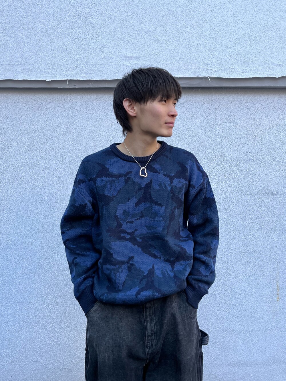 ブルー系のニット/セーター、ブラック系のその他パンツ、グレー系のスニーカーを着用したメンズの冬コーディネートの3枚目の写真