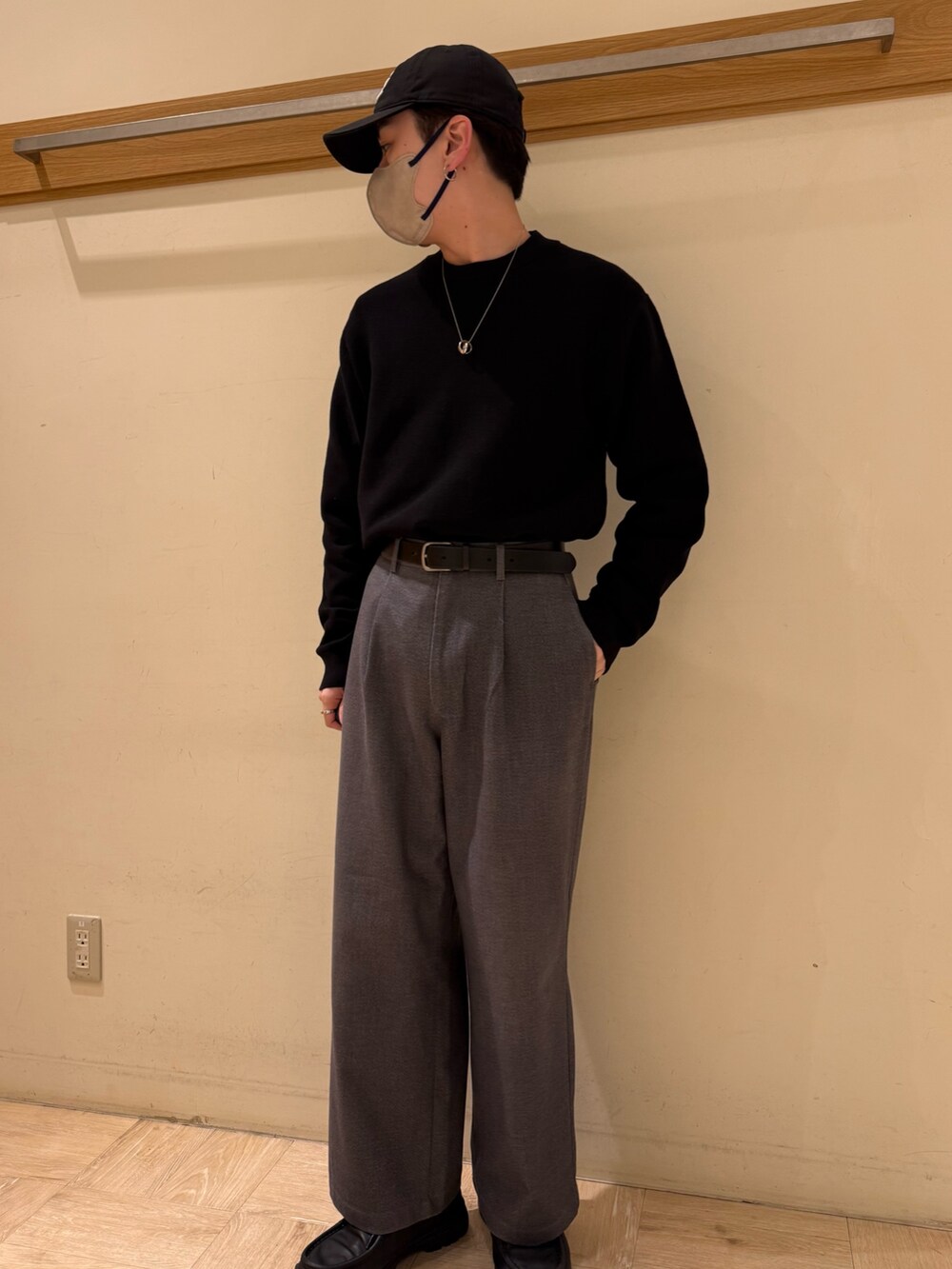 ブラック系のニット/セーター、グレー系のスラックスを着用したメンズの冬コーディネートの8枚目の写真