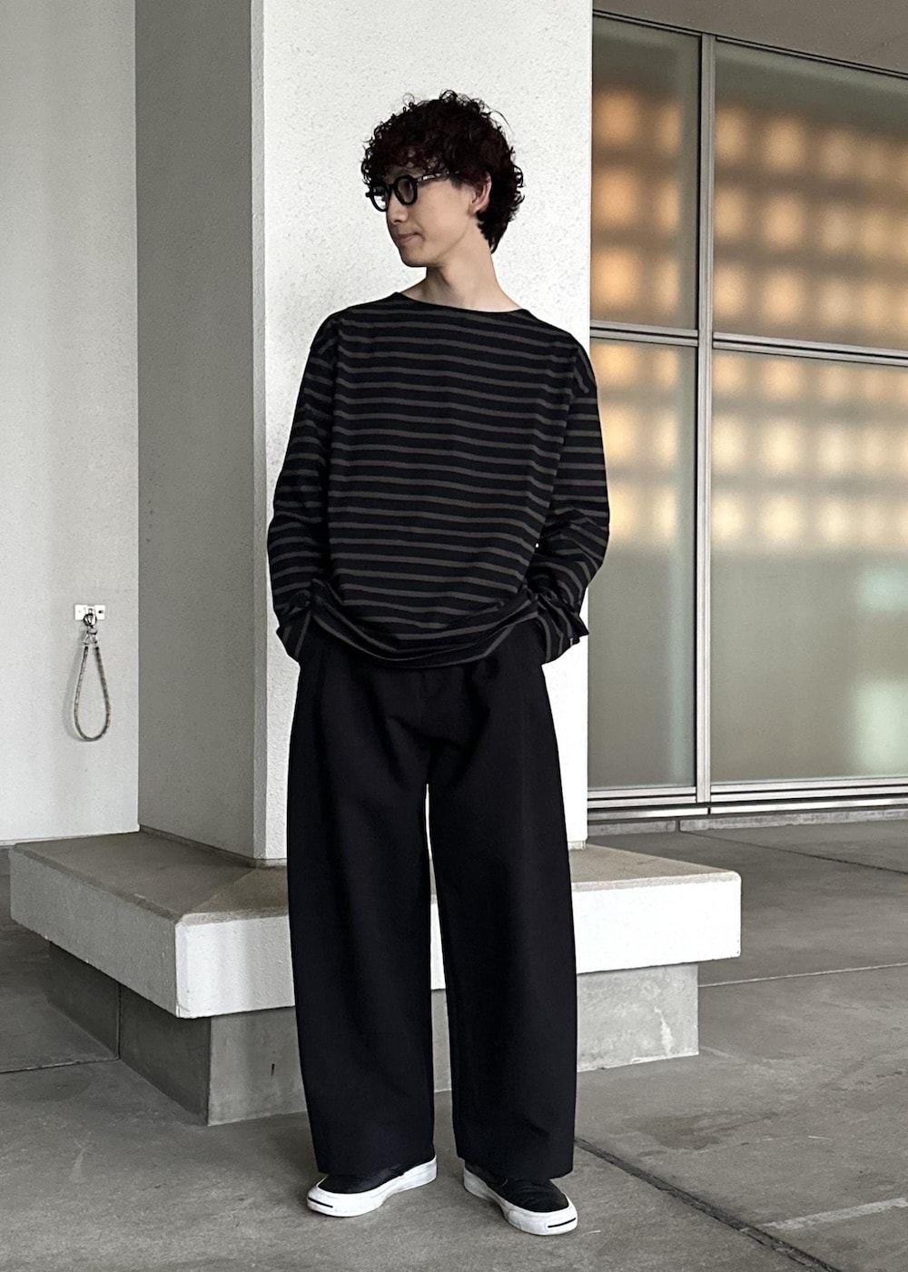 ブラック系のスラックス、ブラウン系のTシャツ/カットソー、ブルー系のセットアップを着用したメンズの春コーディネートの7枚目の写真