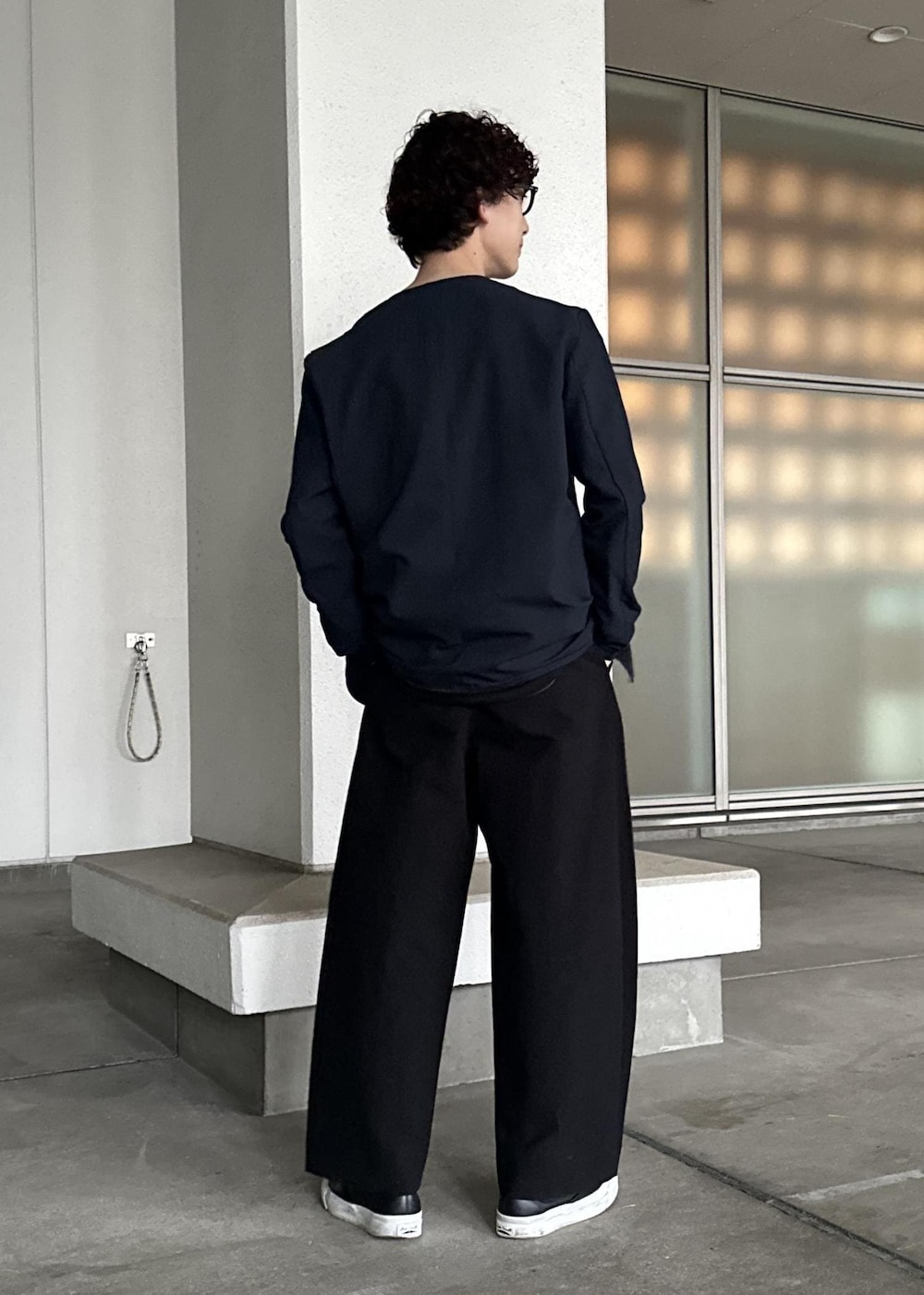 ブラック系のスラックス、ブラウン系のTシャツ/カットソー、ブルー系のセットアップを着用したメンズの春コーディネートの3枚目の写真