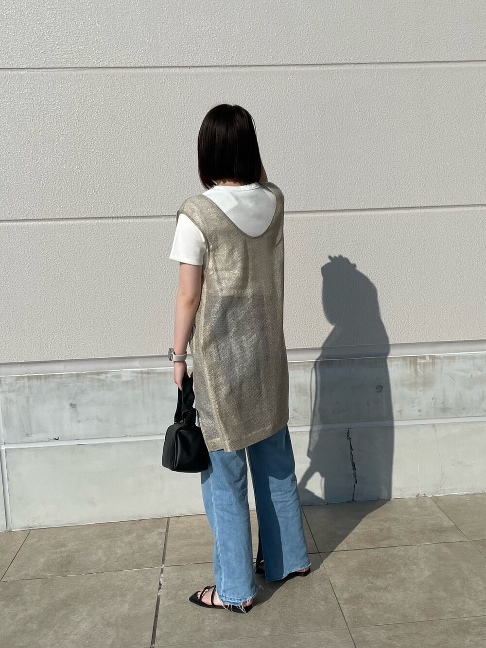 ベージュ系のブルゾン、ホワイト系のTシャツ/カットソー、ブラック系のショルダーバッグを着用したレディースの夏コーディネートの2枚目の写真