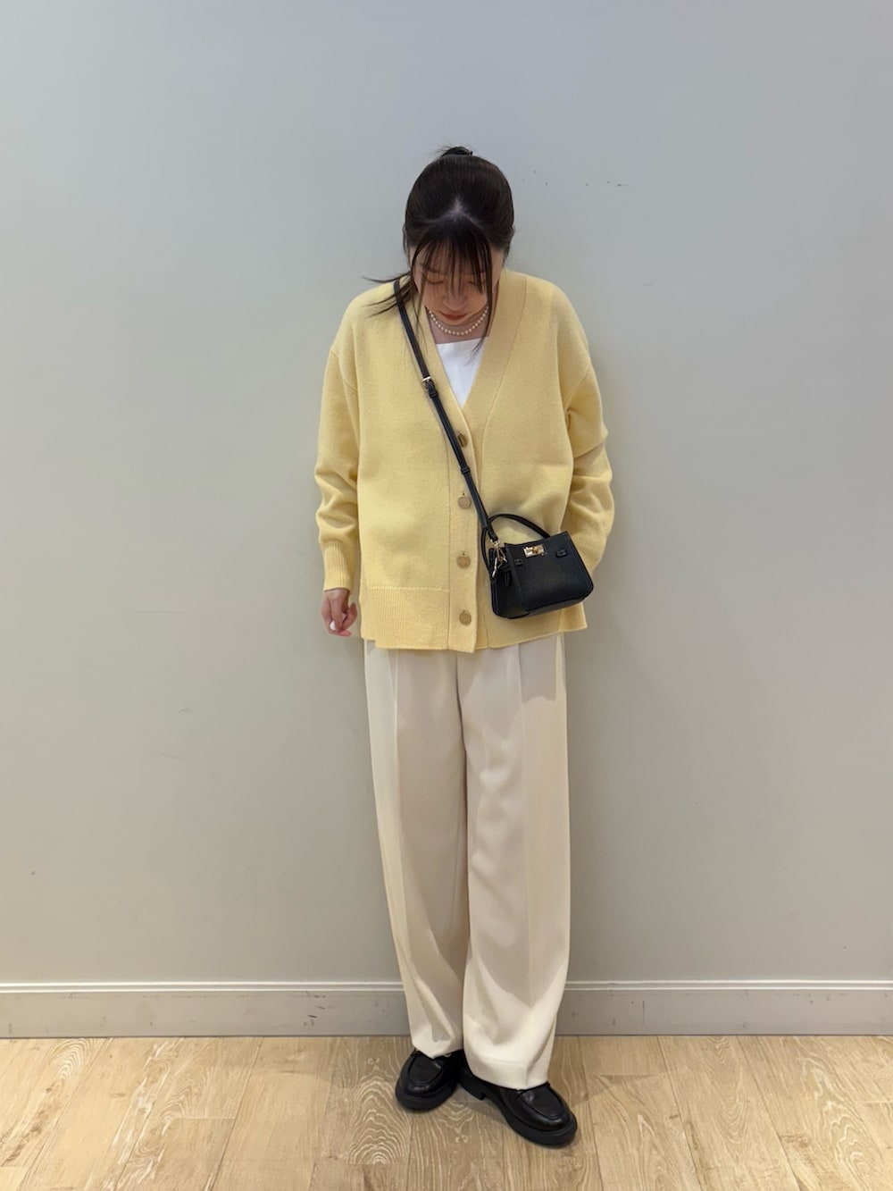 ブラック系のショルダーバッグ、ホワイト系のその他パンツ、ホワイト系のタンクトップを着用したレディースの冬コーディネートの4枚目の写真