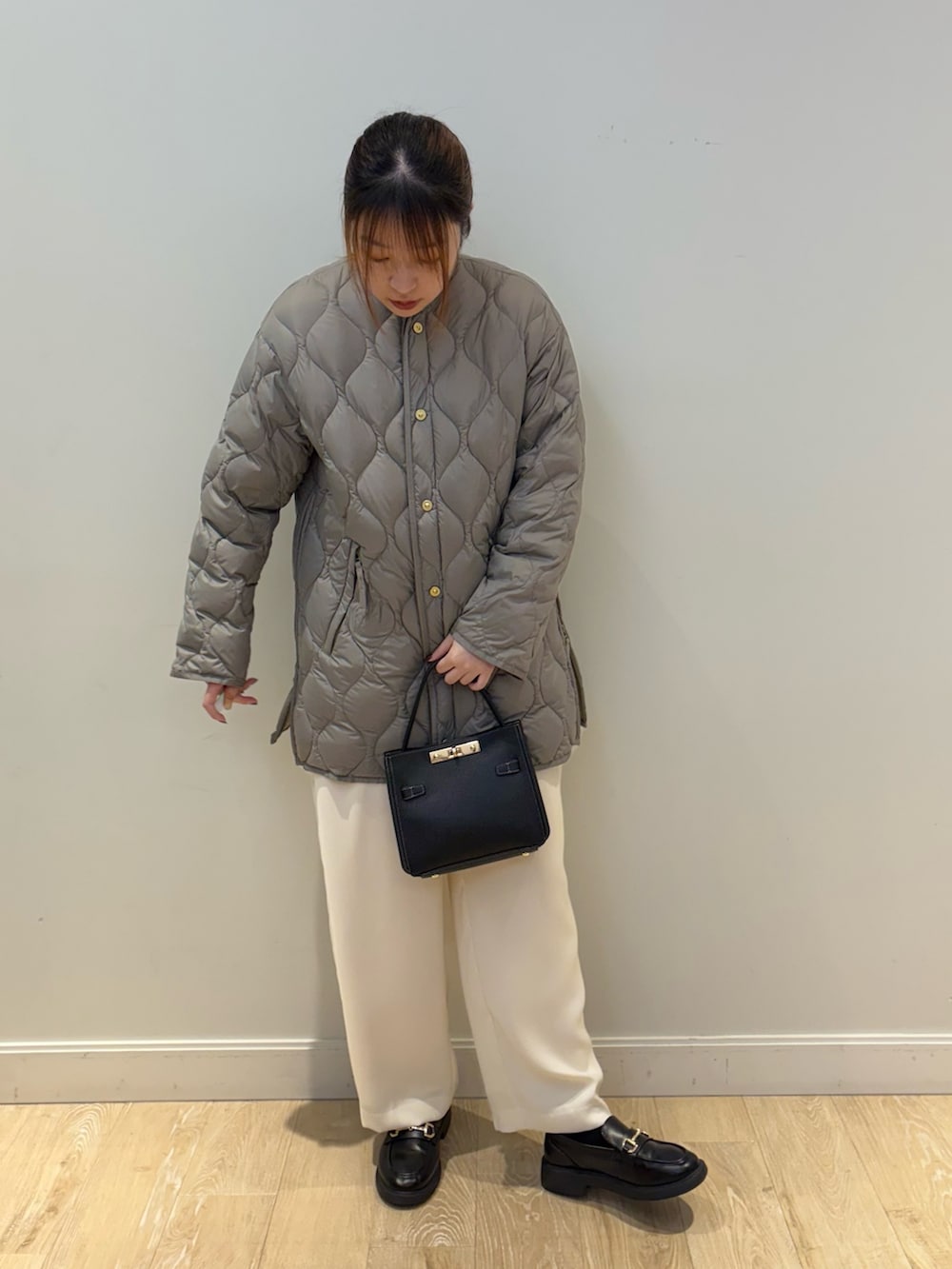 ブラック系のショルダーバッグ、ホワイト系のその他パンツ、ブルー系のニット/セーターを着用したレディースの秋コーディネートの4枚目の写真