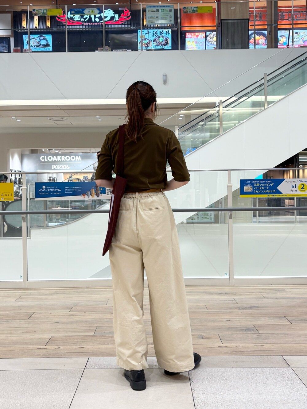 グリーン系のシャツ/ブラウス、ホワイト系のその他パンツ、レッド系のトートバッグを着用したレディースの秋コーディネートの2枚目の写真