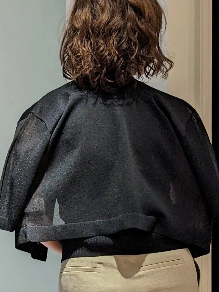 ブラック系のカーディガン/ボレロ、ブラック系のニット/セーター、ベージュ系のその他パンツを着用したレディースの夏コーディネートの4枚目の写真