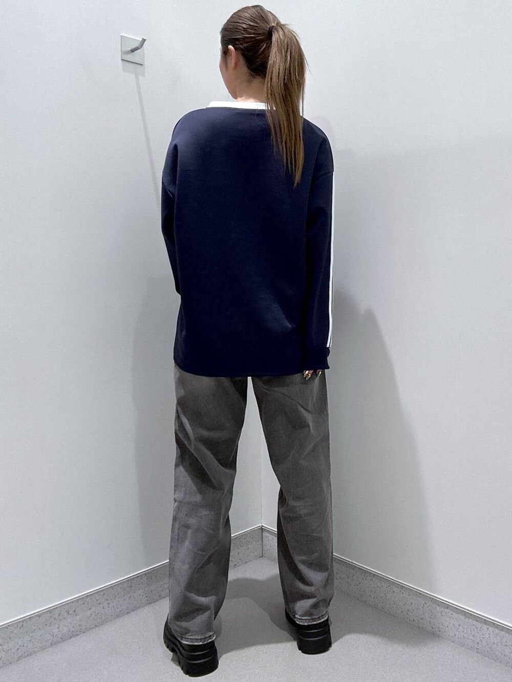 ブラック系のローファー、グレー系のデニムパンツ、ブルー系のTシャツ/カットソーを着用したレディースの冬コーディネートの3枚目の写真