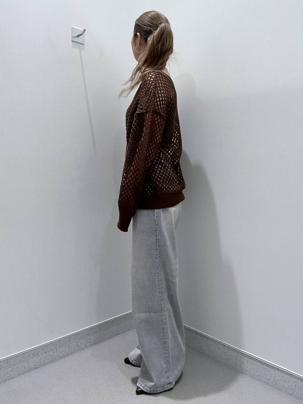 ブラウン系のサンダル、ブラック系のキャミソール、ブルー系のデニムパンツを着用したレディースの冬コーディネートの2枚目の写真