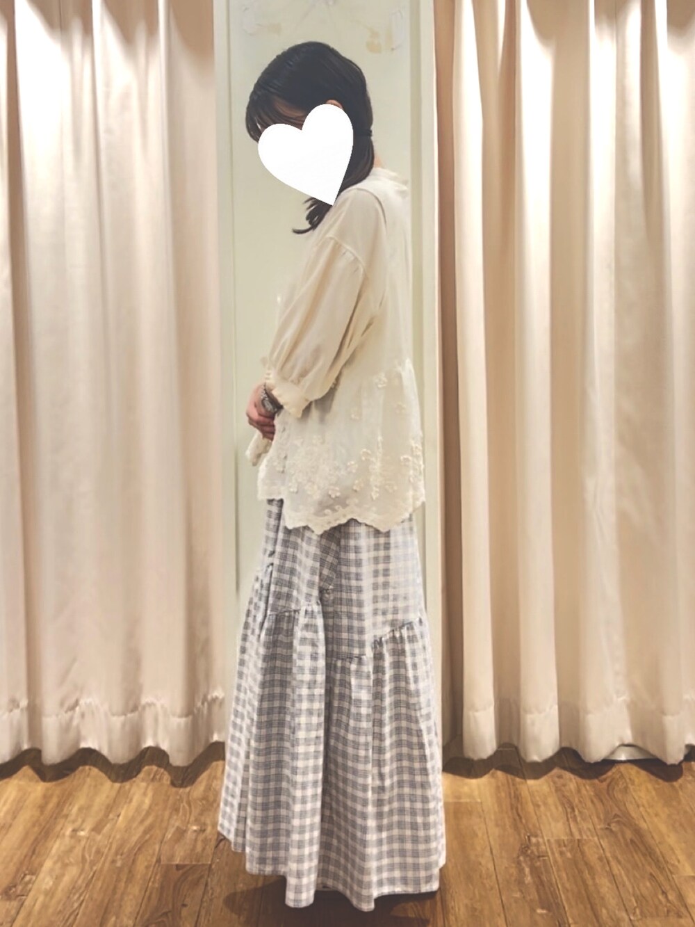 ブルー系のスカート、ホワイト系のベスト、ホワイト系のTシャツ/カットソーを着用したレディースの夏コーディネートの2枚目の写真