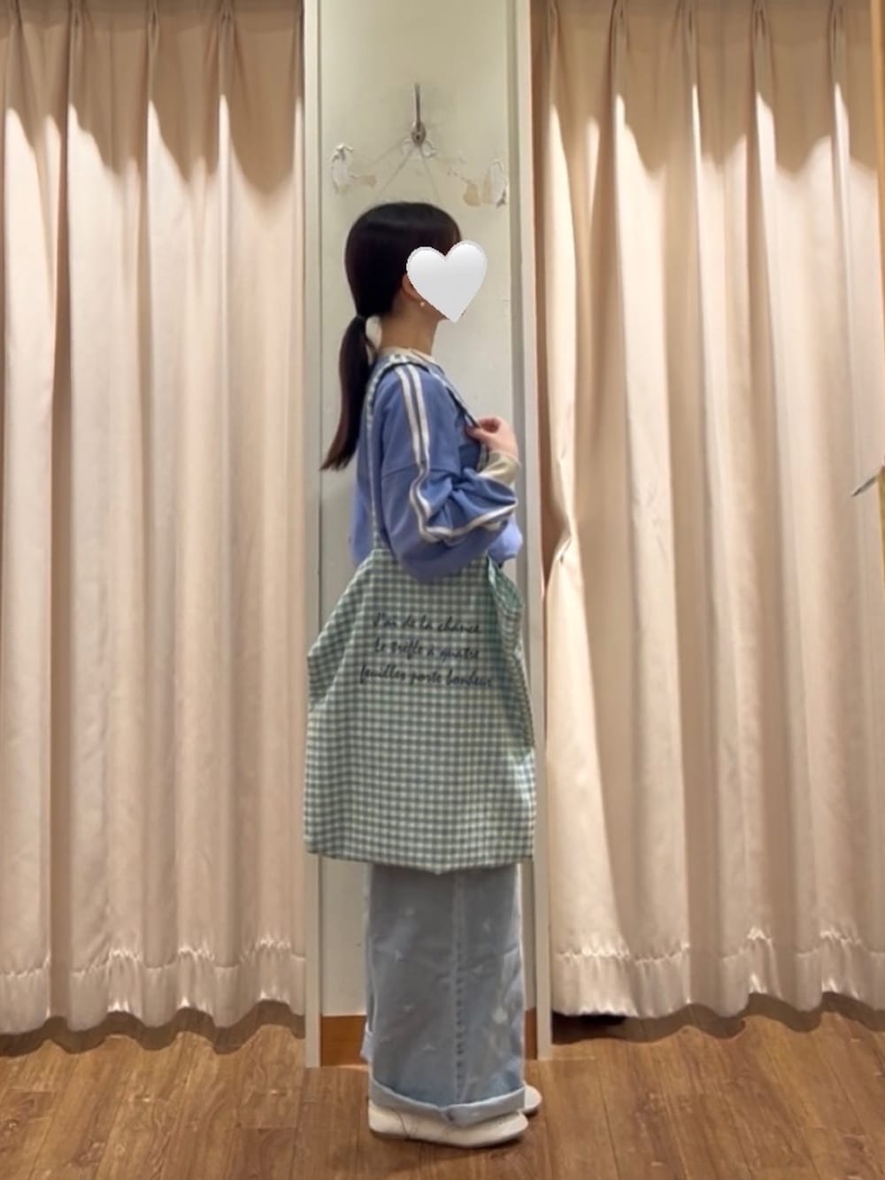 イエロー系のハンドバッグ、ホワイト系のドレスシューズ、ブルー系のその他パンツを着用したレディースの冬コーディネートの2枚目の写真