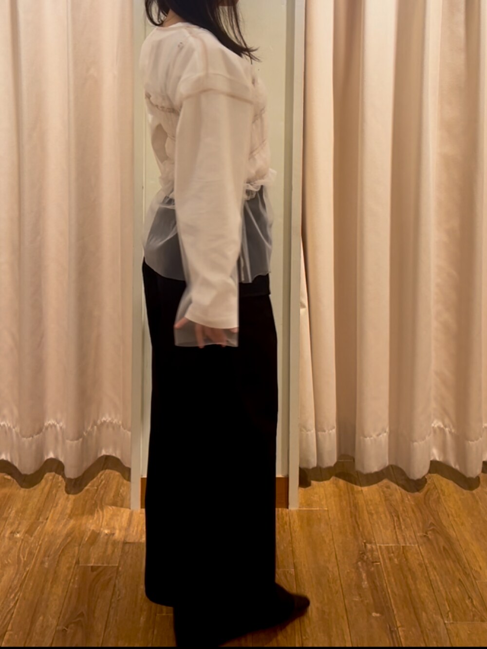 ブラック系のカーゴパンツ、ベージュ系のトップス、ホワイト系のTシャツ/カットソーを着用したレディースの春コーディネートの3枚目の写真