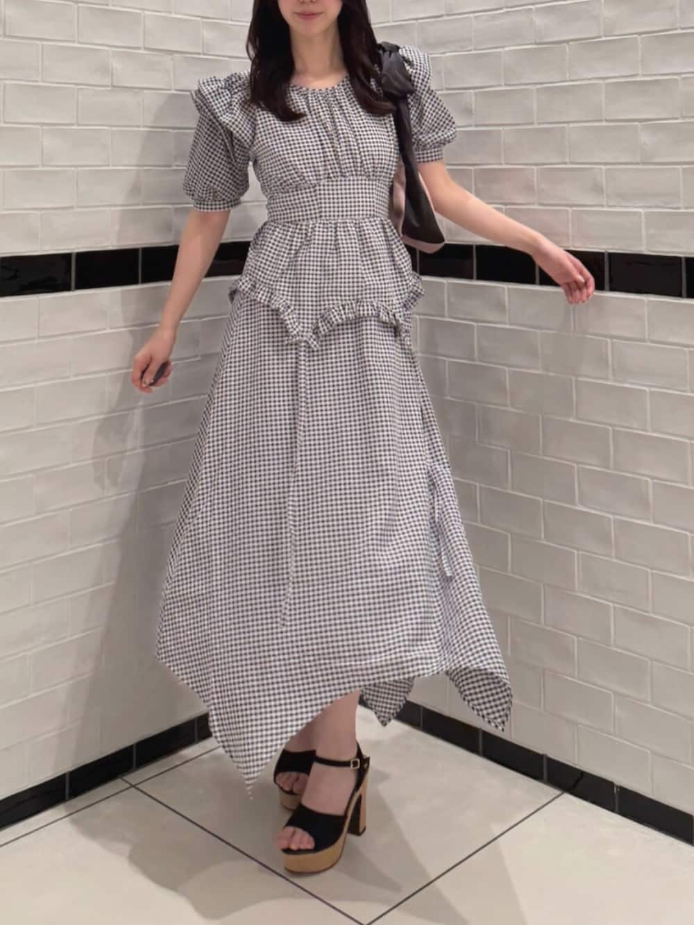 その他のワンピース、ブラック系のサンダル、ピンク系のハンドバッグを着用したレディースの夏コーディネートの2枚目の写真