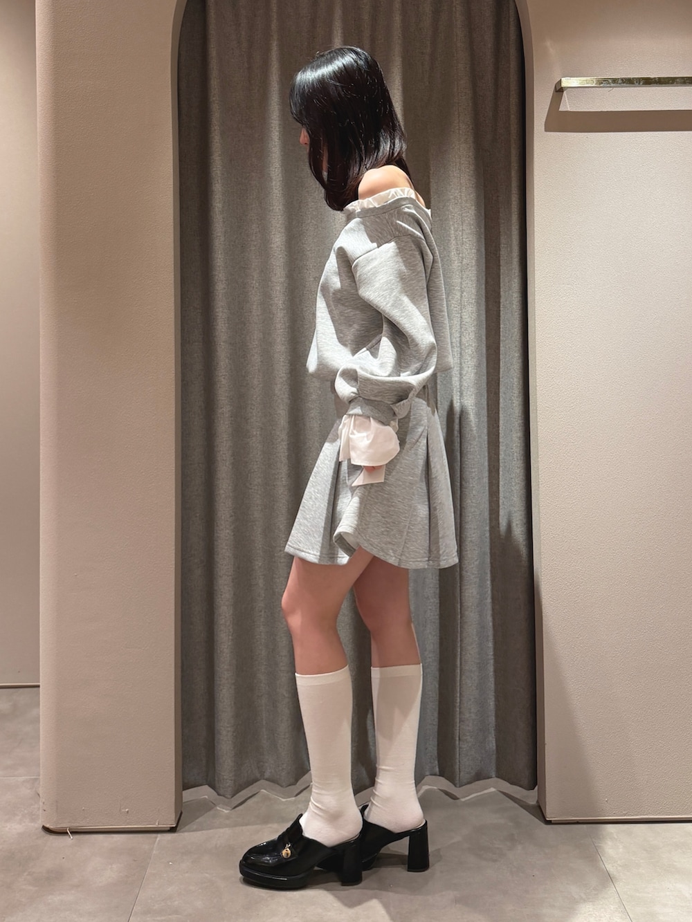 グレー系のTシャツ/カットソー、グレー系のスカート、ブラック系のパンプスを着用したレディースの春コーディネートの3枚目の写真