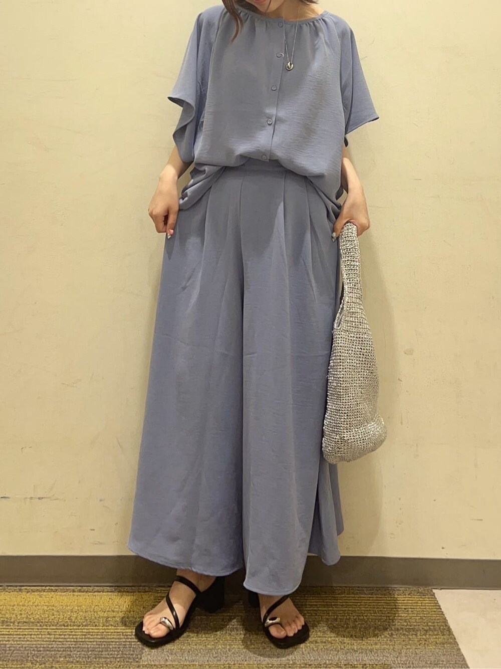 ブルー系のシャツ/ブラウス、ブルー系のその他パンツ、シルバー系のトートバッグを着用したレディースの春コーディネートの6枚目の写真
