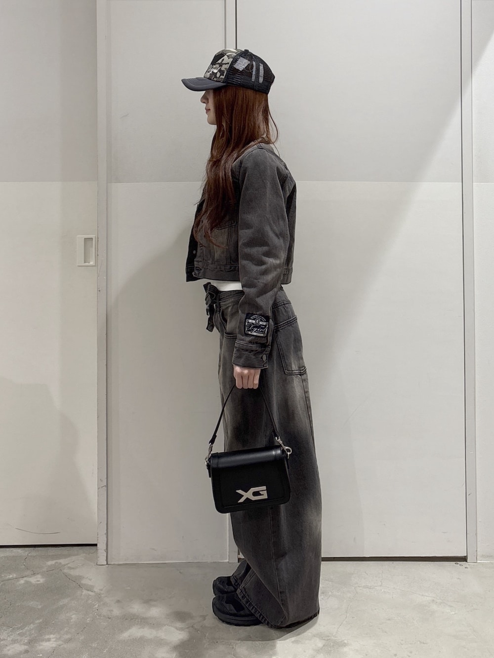 ブラック系のデニムパンツ、ブラック系のデニムジャケット、ホワイト系のTシャツ/カットソーを着用したレディースの春コーディネートの2枚目の写真