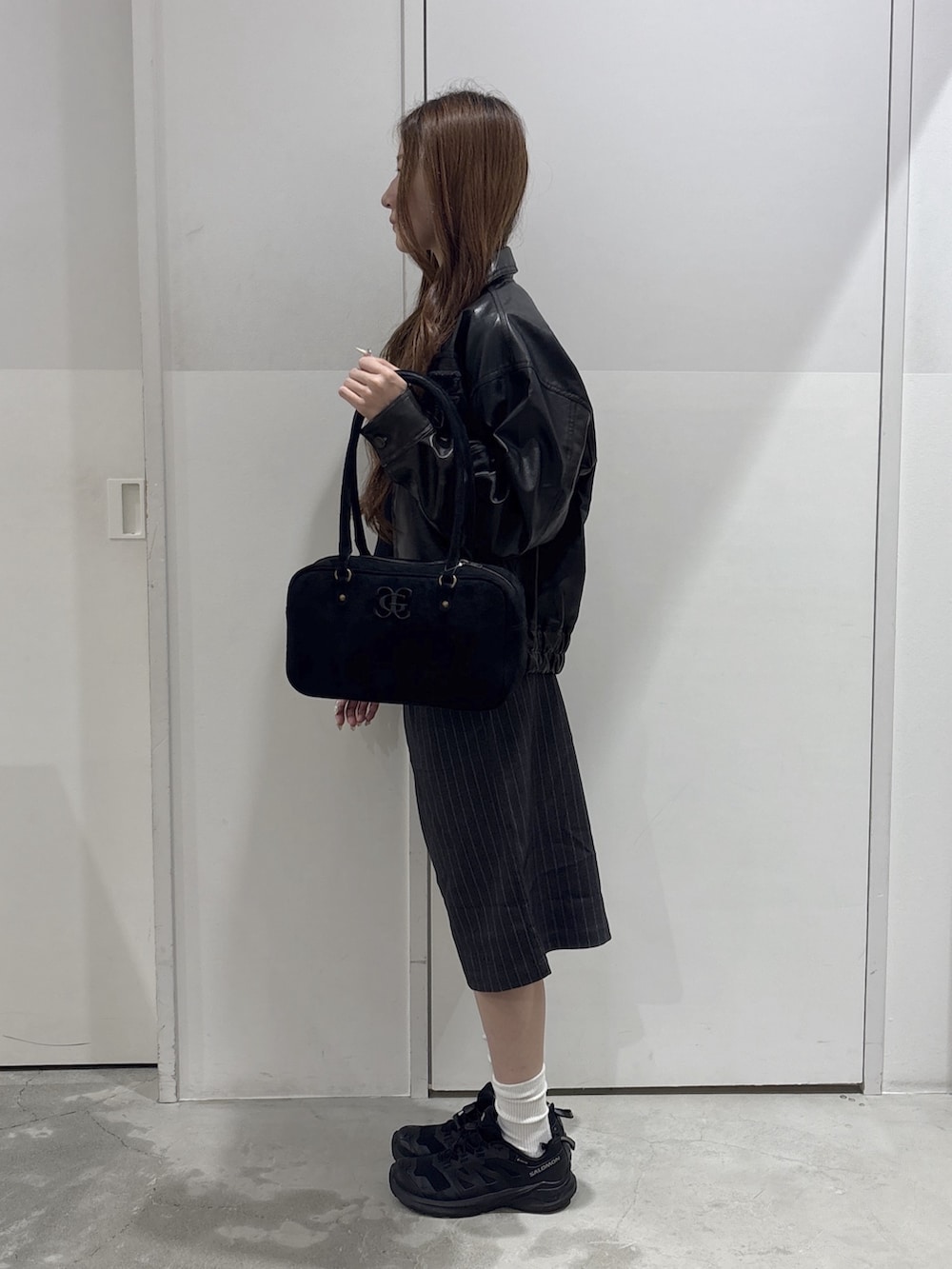 グレー系のその他パンツ、ブラック系のハンドバッグ、ブラック系のブルゾンを着用したレディースの秋コーディネートの2枚目の写真